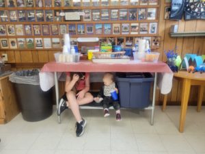 Kids hiding under a table