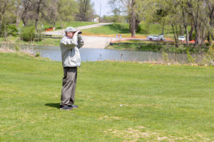 Man using golf range finder