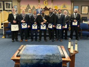 freemasons standing for a posed photo in the lodge room