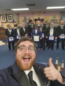 Group of masons standing in the front of their lodge room
