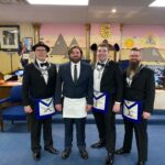 4 Master Masons standing at the front of the lodge room